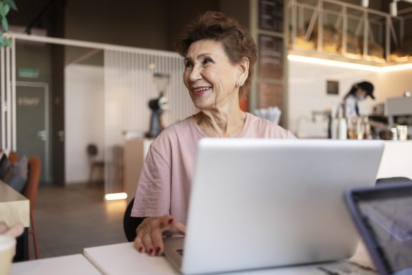 senior-woman-working-her-laptop-cafe